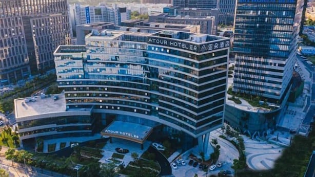 A multi-story hotel with a modern design, featuring a prominent sign for the Atour Hotel. - Atour Hotel (Shenzhen)
