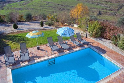 Luxury villa on mountainside with sea views and private pool.
