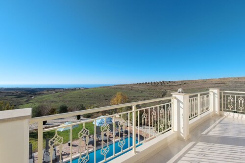 Luxury villa on mountainside with sea views and private pool.