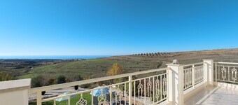 Luxury villa on mountainside with sea views and private pool.