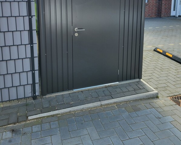 A closed, dark-colored metal door with a keyhole and a handle.