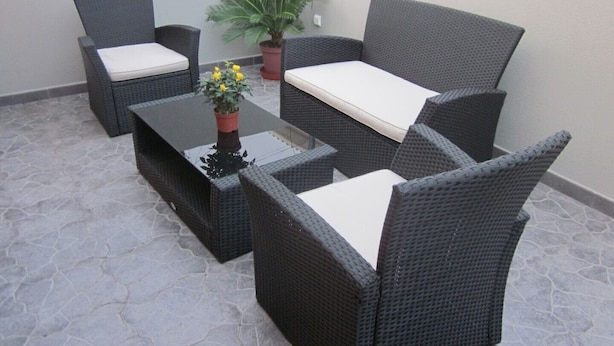A patio area with wicker furniture, including a sofa and chairs, and a small table with a potted plant. - Apartment A  Rosy Apartments (Madeira)
