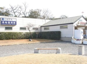 Located near Takematsu Station, this building offers a tranquil setting with a small garden and seating area.