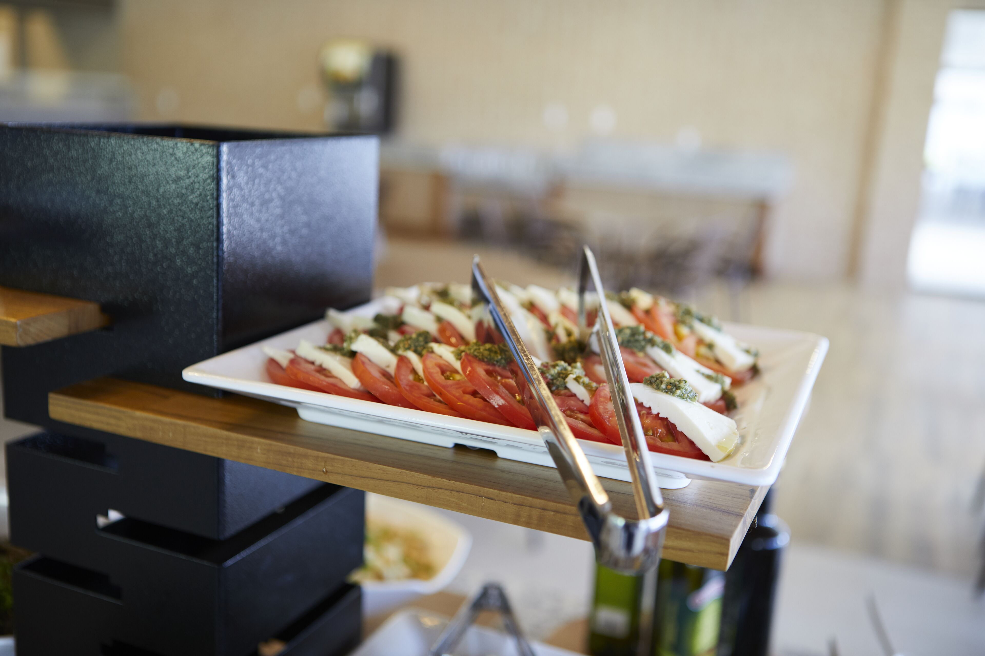 A plate of food on a wooden table with a blurred background.