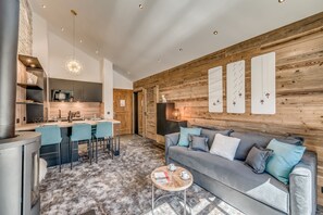 A modern living space with a kitchen, dining area, and a cozy seating area.