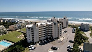 A high-rise hotel with multiple balconies overlooking the beach. - The Beach Hive: Ocean view condo in the heart of Emerald Isle (Emerald Isle)