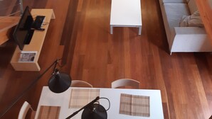 A modern living room with a grey sofa, a white coffee table, and a TV on a wooden stand. - RURAL HOUSE AINGERU NATURE AND MOUNTAIN (Aránzazu)