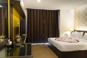 A hotel room with a bed, a desk, a mirror, and a window with curtains. - The Y Boutique Hotel (San Sai)