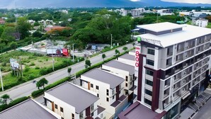A multi-story hotel with a modern design, featuring balconies and a prominent '800' sign. - The Y Boutique Hotel (San Sai)