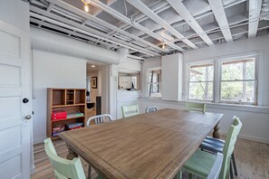 Cozy dining area with a large table and four chairs, perfect for family meals.
