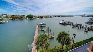 A marina with docks and boats, surrounded by buildings and greenery.
