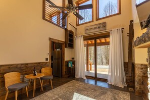 Enjoy a casual dining experience in this inviting space with a dining area, sliding glass door, and rustic charm.