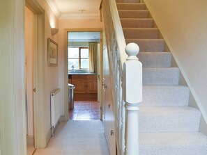 A staircase with a white balustrade leading to a landing.