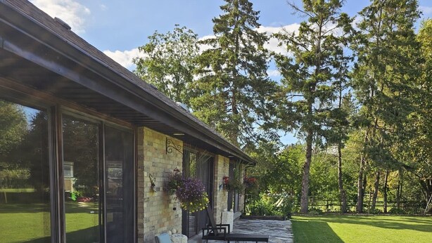 A patio with two lounge chairs and a stone pathway. - ***OASIS*** (Ingersoll)
