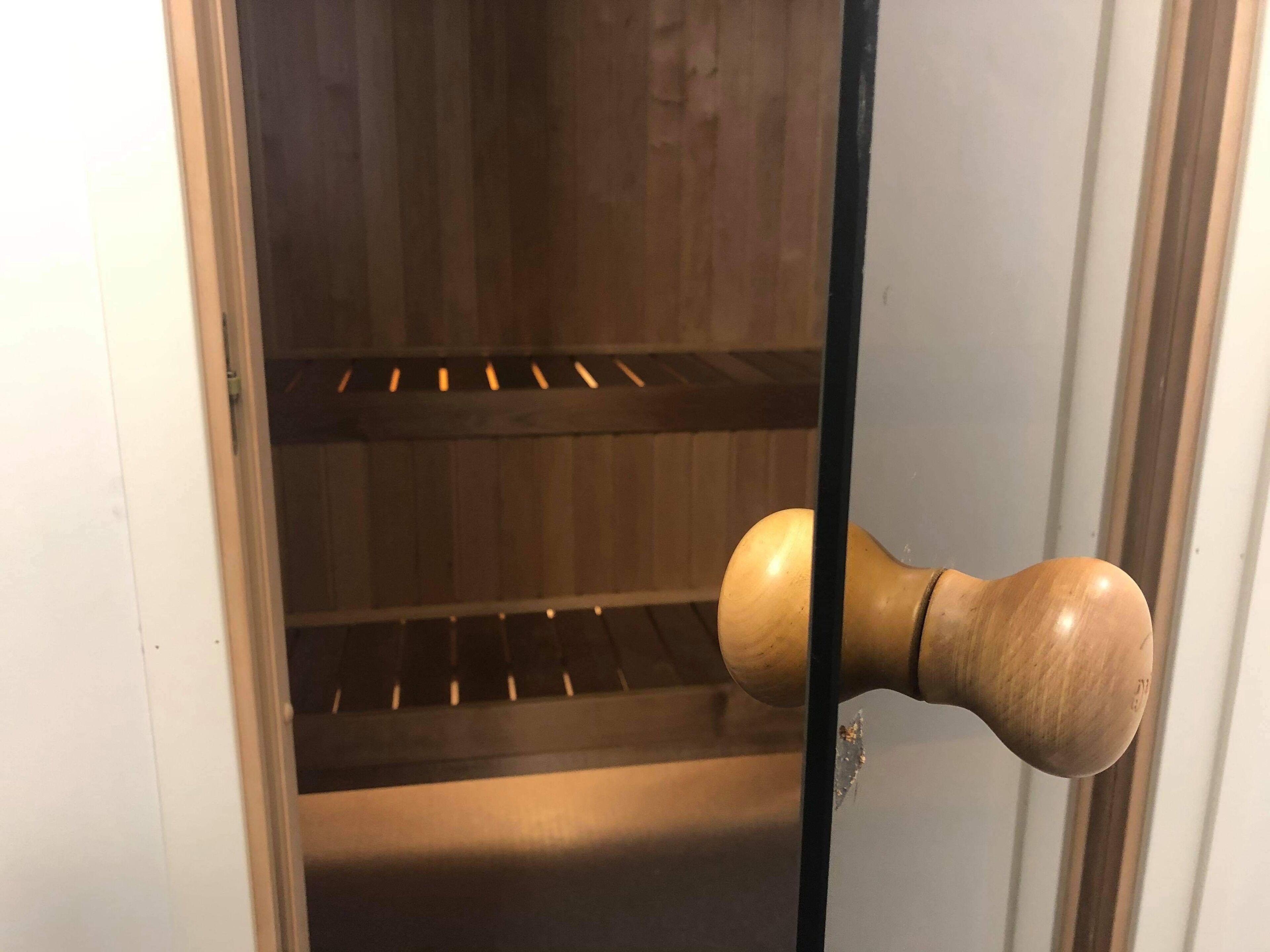 A wooden door with a simple, modern handle.