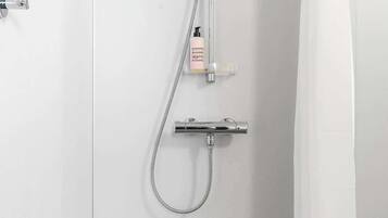 A shower with a handheld showerhead and a handheld shower attachment.