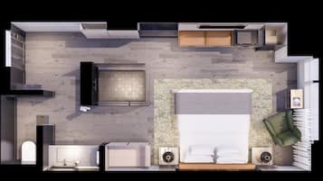 A modern hotel room layout with a large bed, a green armchair, a small desk, a built-in wardrobe, and a bathroom with a shower and sink.
