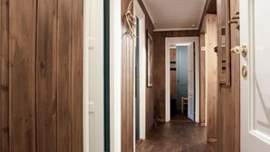 A wooden hallway with doors and a framed picture on the wall. - Stunning apartment in Hemsedal (Hemsedal)