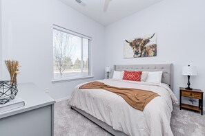 A bedroom with a bed, bedside tables, a window with blinds, and a wall-mounted artwork. - *LUXURY WALK IN THE PARK-2* (Fishers)