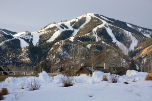 A mountain landscape with a cabin and a bridge in the background. - Lodge Apt. II Condominiums by Alpine Lodging Sun Valley (Sun Valley)