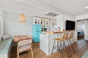 Fridge, microwave, cookware/dishes/utensils, dining tables