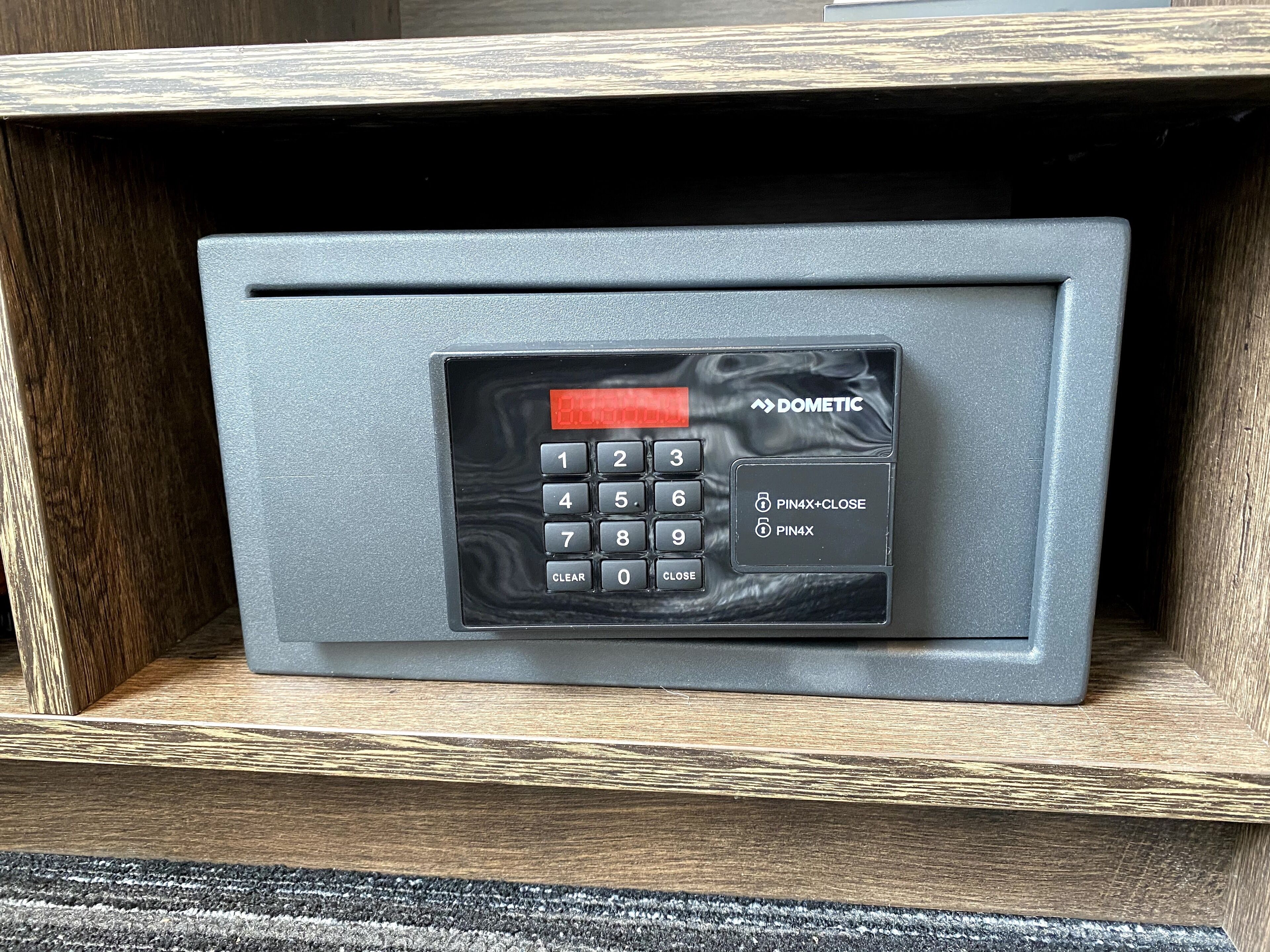 A secure storage unit with a numeric keypad and a PIN entry system, labeled "DOMETIC."