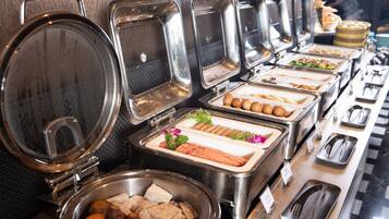 A buffet with various food items and utensils.