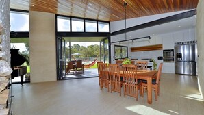 A spacious, modern kitchen with a large island, stainless steel appliances, and a view of the outdoors. - Stunning home on 5 acres with Infinity Pool & Fireplace (Herron)