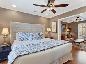 Cozy retreat with a tufted headboard, plush bed, and comfortable seating area.