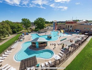Relax by the resort's large, winding pool surrounded by lounge chairs and umbrellas.