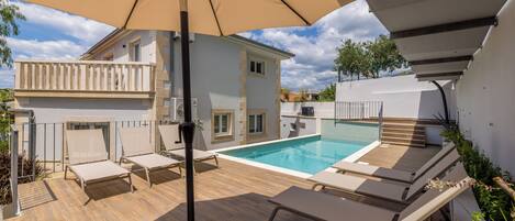 Outdoor pool, a heated pool, sun loungers