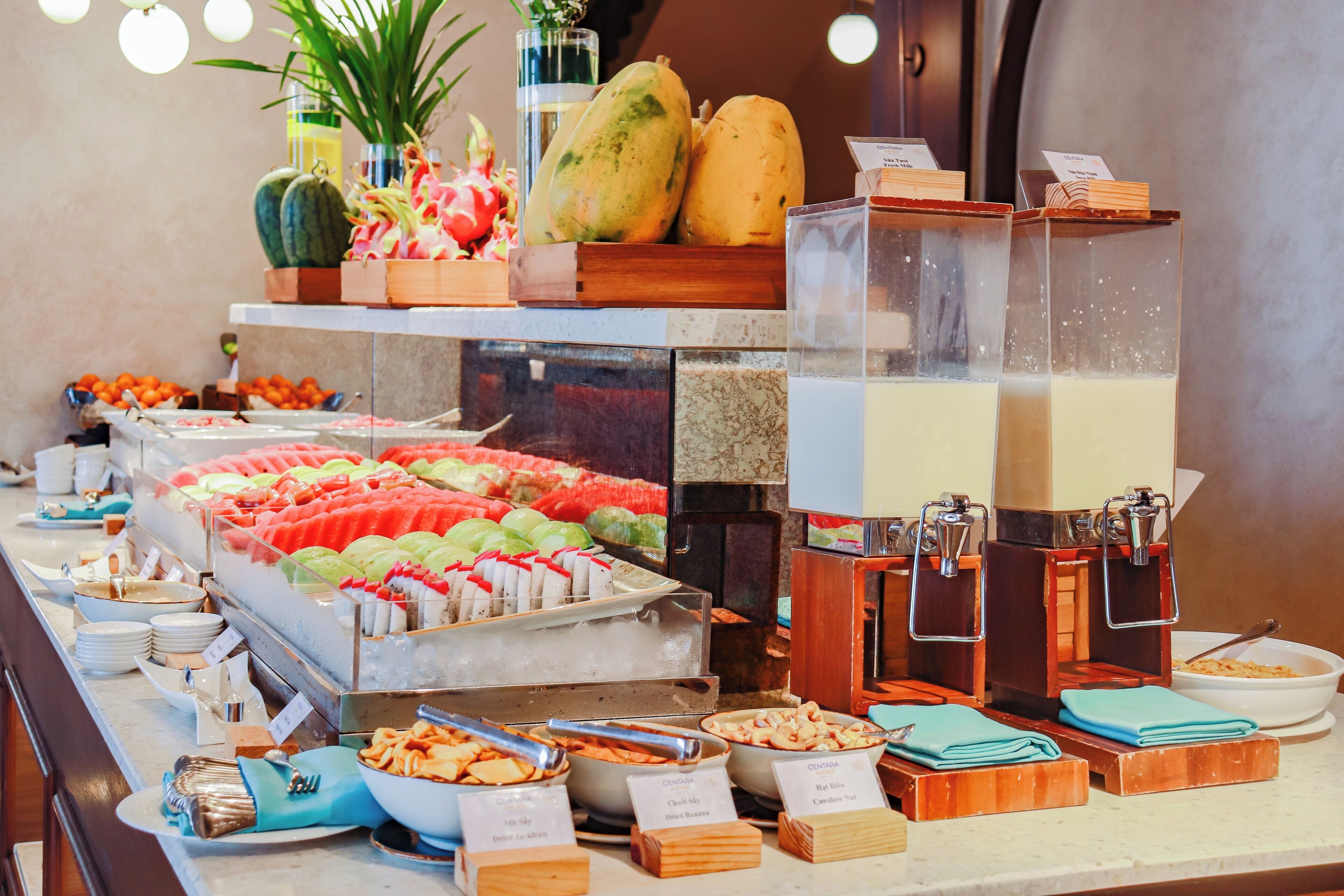 A buffet with various food items and a coffee station.