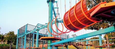 A playground with a large slide and climbing structures.