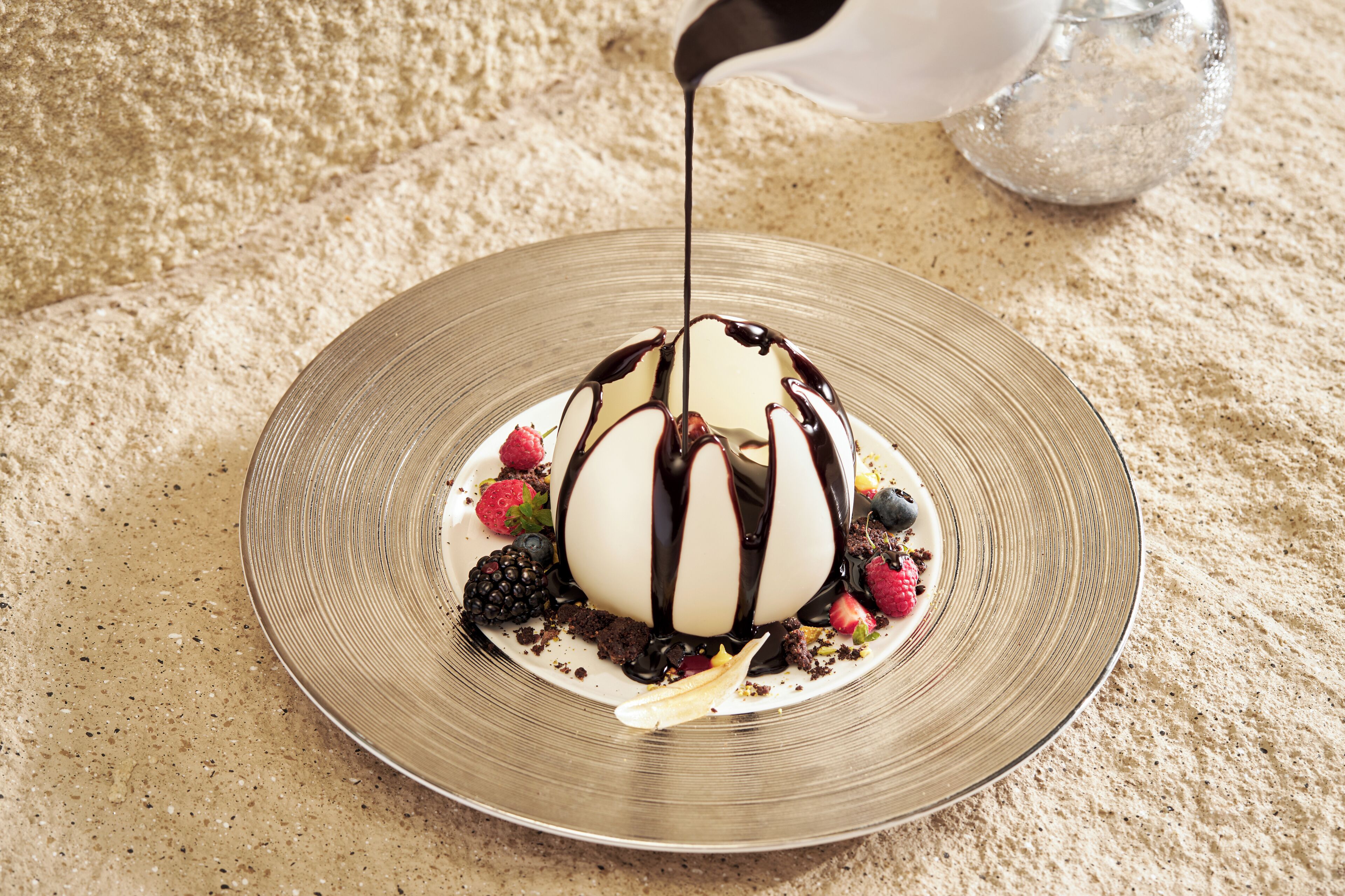 A dessert on a plate with chocolate drizzle.