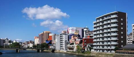 A cityscape with various buildings, including a hotel with a sign indicating it is a hotel.