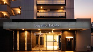 The exterior of Legatio Hakata hotel with a modern design, featuring a prominent entrance, illuminated signage, and a clear view of the interior through the glass doors. - Legatio HAKATA (Fukuoka)