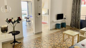 A modern living room with a TV, seating, and a view to a balcony. - The fisherman's house (Sciacca)
