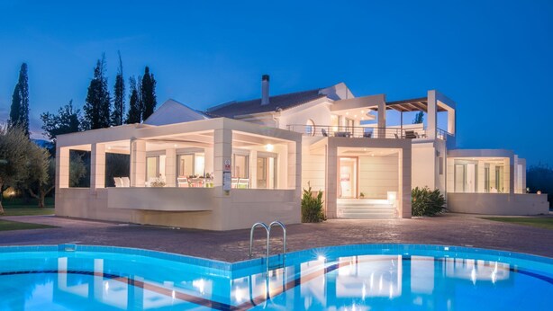 A modern house with a swimming pool, large windows, and a covered outdoor area. - Astarte Villas - Istar Luxurious Villa with Private Pool and Tennis Court (QR8G+MXJ Artemisia, Greece)
