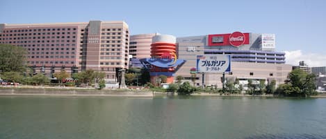 A hotel with a large sign, a Coca-Cola logo, and a large water tower.