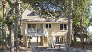 A two-story house with a balcony and a staircase leading to a covered porch. - 2 BR + Loft/2BA Tarpon Pond Cottage! Great Views! Amenity access included (Seabrook Island)