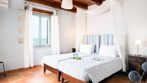 A bedroom with a wooden ceiling, a bed with a canopy, a bedside table with a lamp, and a window with curtains. - Beachfront villa w/private pool, ping pong and BBQ (Chania)