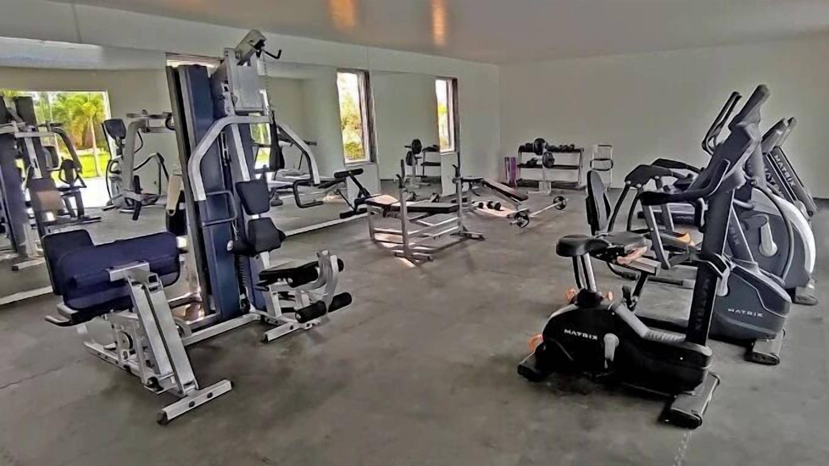 A gym with various exercise equipment, including treadmills and weight machines.