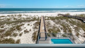 A beach view from a balcony with a pool. - Another Round by GSVR | Beachfront w/ Pool & Elevator | Free Activities/Golf (Gulf Shores)