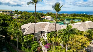 A resort with a pool, palm trees, and a view of the ocean. - Private and Sweet Wailea 1 BD+2 BA Grand Champions Villa (Wailea)