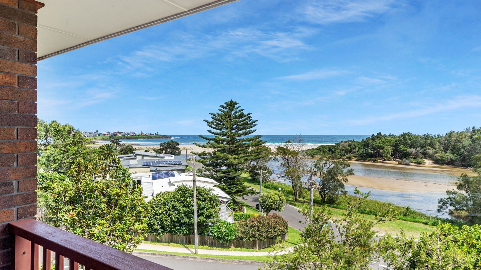 A residential area with a view of a beach and a river.