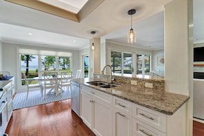 Enjoy a well-lit kitchen with a large window offering a view of the surrounding landscape.