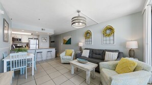 A modern living space with a kitchen, dining area, and seating area.