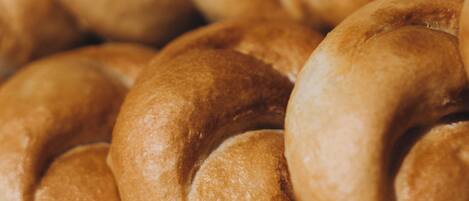 A close-up of a pile of golden-brown bread rolls.