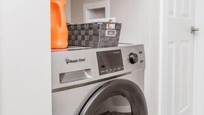 A front-loading Magic Chef washing machine in a laundry room with a white door and light-colored flooring. - OSU 6D · Newly Renovated (6D) OSU/Central ❤Near EVERYTHING (Columbus)