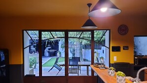 A modern kitchen with a large window, a wooden countertop, and a hanging light fixture. - Mas " La Maison de mon Père " Avignon à 10 Minutes, Village de Pujaut 30131 (Pujaut)